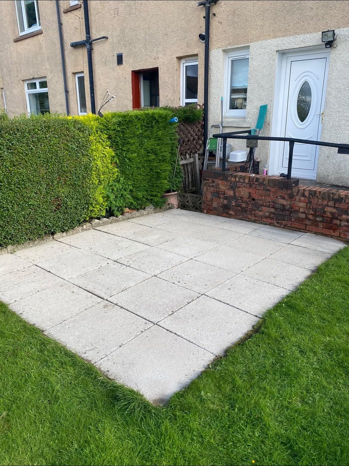 The same front garden patio slabs clean and bright after pressure washing