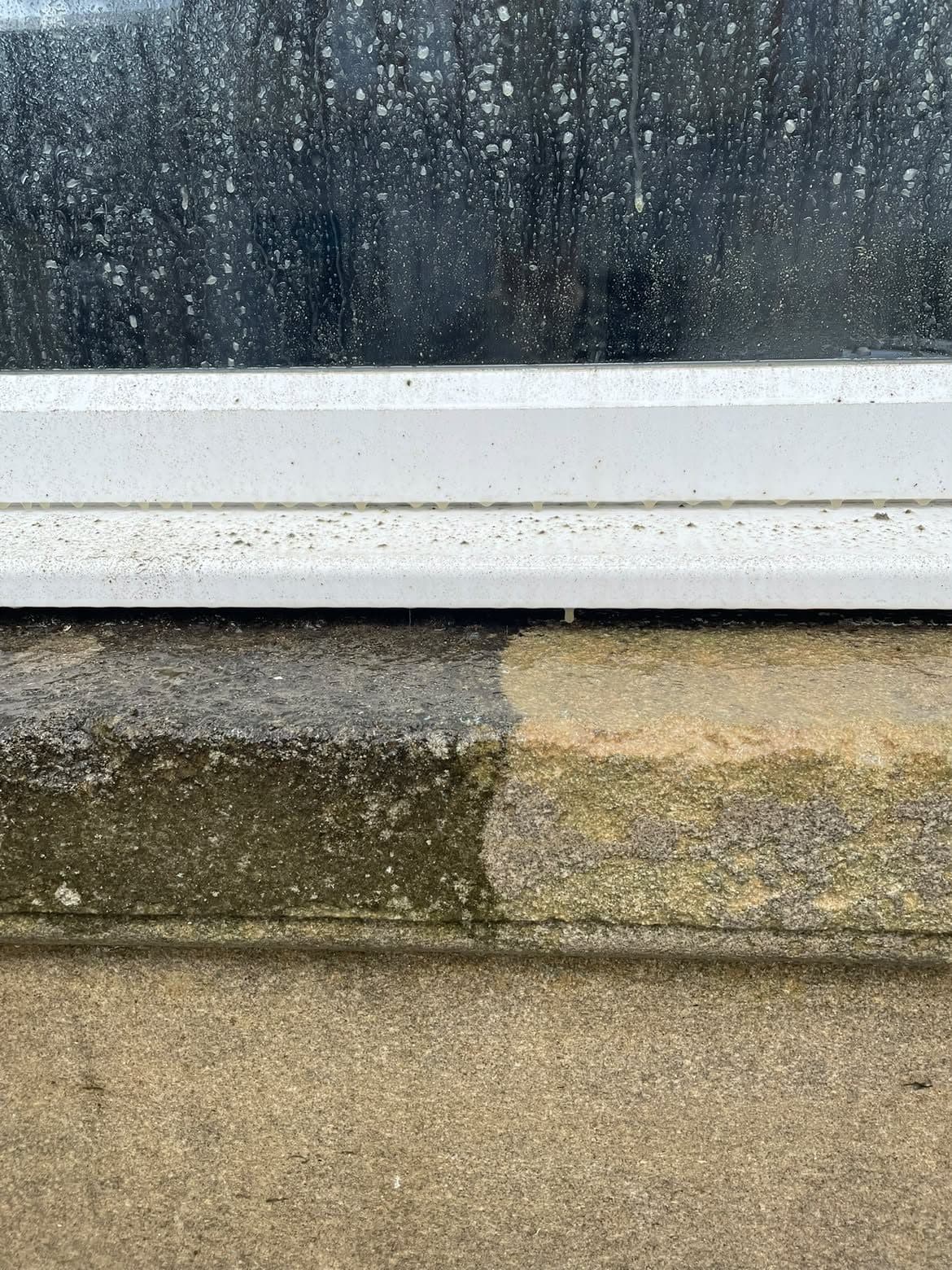 Stone window sill half cleaned, showing the difference against the dirty half